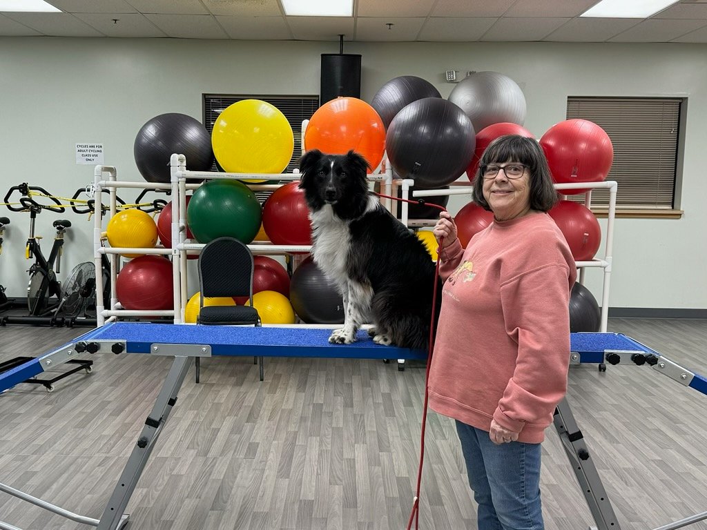 A student and her Australian shepherd at the agility bridge during a Brown County K9 group class at the Brown County YMCA